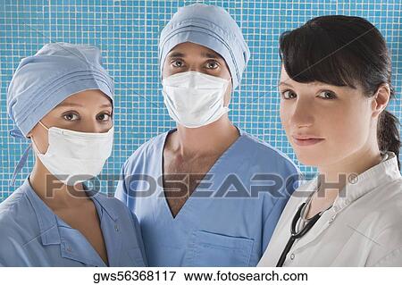 Portrait of a female doctor with two surgeons View Large Photo Image Stock Photo - Portrait of a female doctor with two surgeons. Fotosearch