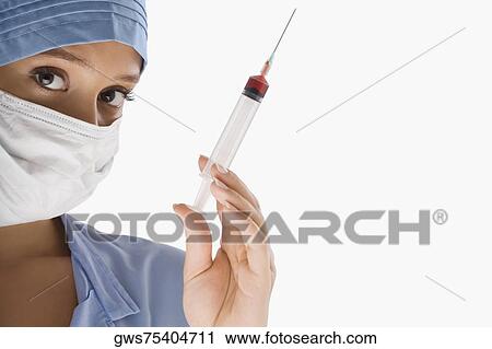 Portrait of a female surgeon holding a syringe View Large Photo Image Stock Image - Portrait of a female surgeon holding a syringe. Fotosearch