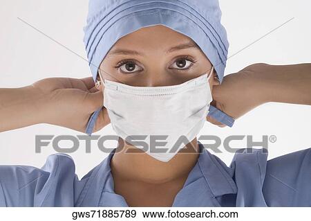 Stock Photo - Portrait of a female surgeon holding a syringe. Fotosearch