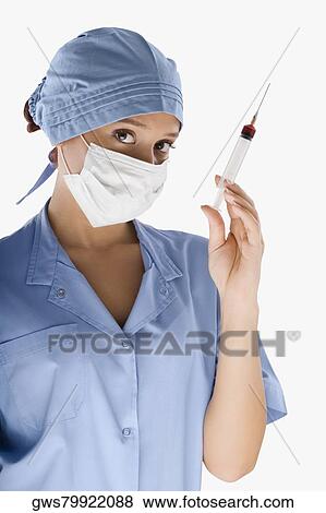 Portrait of a female surgeon holding a syringe View Large Photo Image Stock Photo - Portrait of a female surgeon holding a syringe. Fotosearch