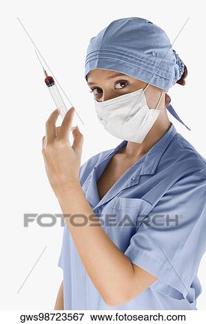 Portrait of a female surgeon holding a syringe View Large Photo Image Stock Photo - Portrait of a female surgeon holding a syringe. Fotosearch