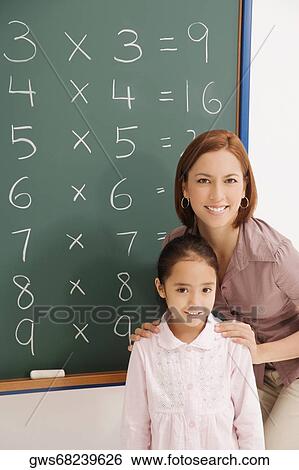 Portrait of a female teacher smiling with her student View Large Photo Image Stock Photograph - Portrait of a female teacher smiling with her student. Fotosearch