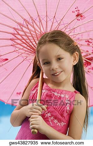 Portrait of a girl holding a parasol and smiling View Large Photo Image Stock Photography - Portrait of a girl holding a parasol and smiling. Fotosearch