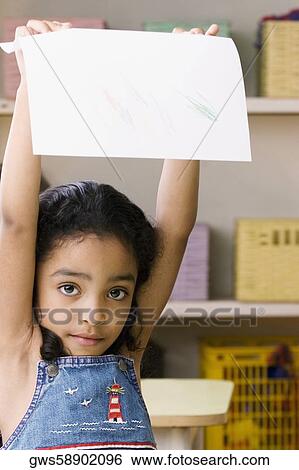 Portrait of a girl showing a drawing View Large Photo Image Stock Photograph - Portrait of a girl showing a drawing. Fotosearch