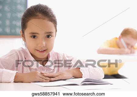 Portrait of a girl sitting in a classroom View Large Photo Image Stock Image - Portrait of a girl sitting in a classroom. Fotosearch