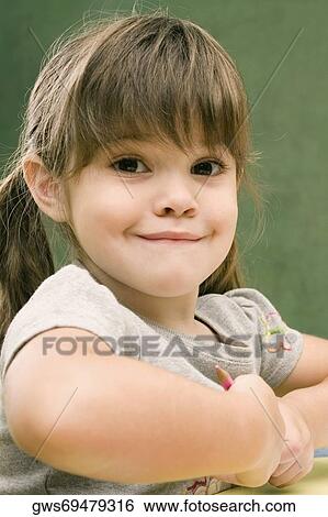 Portrait of a girl smirking View Large Photo Image Stock Photograph - Portrait of a girl smirking. Fotosearch