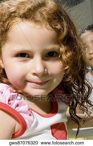 Portrait of a girl smirking with her classmate in the background View Large Photo Image Stock Image - Portrait of a girl smirking with her classmate in the background. Fotosearch