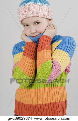 Portrait of a girl standing with holding her sweater View Large Photo Image Picture - Portrait of a girl standing with holding her sweater. Fotosearch