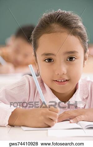 Portrait of a girl studying in a classroom View Large Photo Image Stock Photo - Portrait of a girl studying in a classroom. Fotosearch