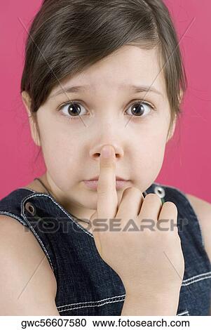 Portrait of a girl touching her nose View Large Photo Image Stock Image - Portrait of a girl touching her nose. Fotosearch