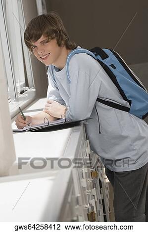 Portrait of a high school student writing in a ring binder View Large Photo Image Stock Image - Portrait of a high school student writing in a ring binder. Fotosearch