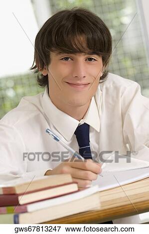 Portrait of a high school student sitting in a classroom View Large Photo Image Stock Photo - Portrait of a high school student sitting in a classroom. Fotosearch