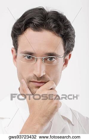 Stock Image - Portrait of a male doctor looking serious. Fotosearch