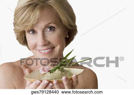 Portrait of a mature woman holding a bowl of face pack View Large Photo Image Stock Image - Portrait of a mature woman holding a bowl of face pack. Fotosearch