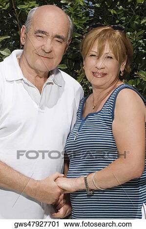 Portrait of a senior couple holding hands and smiling View Large Photo Image Stock Image - Portrait of a senior couple holding hands and smiling. Fotosearch