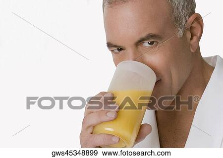 Portrait of a senior man holding a glass of orange juice View Large Photo Image Stock Photo - Portrait of a senior man holding a glass of orange juice. Fotosearch