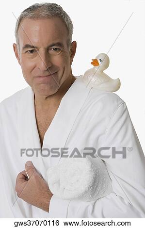 Stock Photograph - Portrait of a senior man holding a folded towel under his arm and smiling. Fotosearch