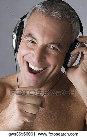 Portrait of a senior man listening to music with headphones and singing View Large Photo Image Stock Image - Portrait of a senior man listening to music with headphones and singing. Fotosearch