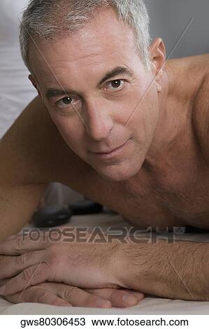 Stock Image - Portrait of a senior man lying on a massage table. Fotosearch
