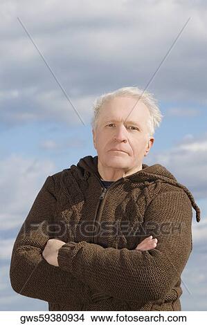 Portrait of a senior man with his arms crossed View Large Photo Image Picture - Portrait of a senior man with his arms crossed. Fotosearch