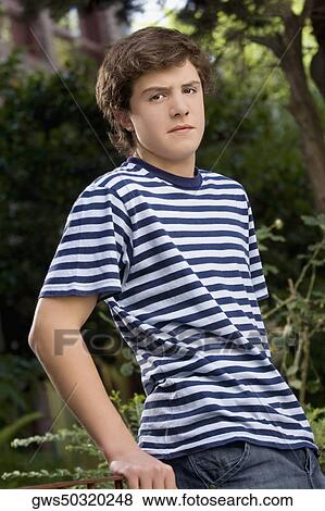 Portrait of a teenage boy looking serious View Large Photo Image Stock Photo - Portrait of a teenage boy looking serious. Fotosearch