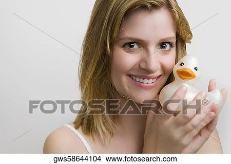 Portrait of a teenage girl holding a rubber duck and smiling View Large Photo Image Picture - Portrait of a teenage girl holding a rubber duck and smiling. Fotosearch