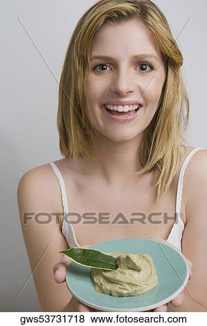 Portrait of a teenage girl holding a bowl of face pack and smiling View Large Photo Image Stock Photo - Portrait of a teenage girl holding a bowl of face pack and smiling. Fotosearch