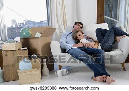 Portrait of a young couple resting on a couch View Large Photo Image Stock Photo - Portrait of a young couple resting on a couch. Fotosearch