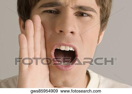 Stock Photo - Portrait of a young man shouting. Fotosearch