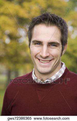 Portrait of a young man smiling View Large Photo Image Stock Photography - Portrait of a young man smiling. Fotosearch