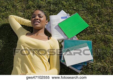 Portrait of a young woman lying on grass and smiling View Large Photo Image Stock Photography - Portrait of a young woman lying on grass and smiling. Fotosearch
