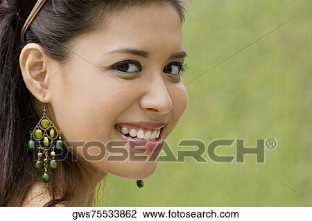 Portrait of a young woman smiling View Large Photo Image Stock Image - Portrait of a young woman smiling. Fotosearch