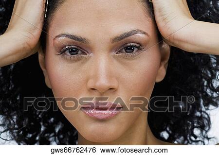 Portrait of a young woman with her head in her hands View Large Photo Image Stock Photograph - Portrait of a young woman with her head in her hands. Fotosearch