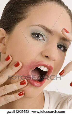 Portrait of a young woman with her messy lips View Large Photo Image Stock Image - Portrait of a young woman with her messy lips. Fotosearch
