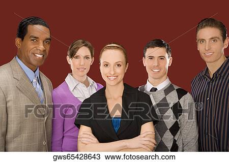 Stock Image - Portrait of business executives standing together and smiling. Fotosearch
