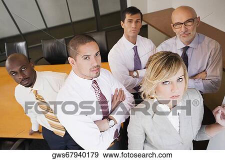 Stock Photo - Portrait of business executives standing in a board room. Fotosearch