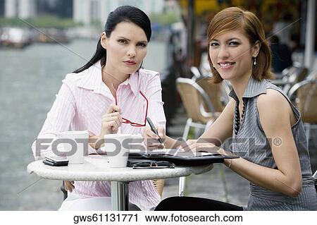 Portrait of two businesswomen sitting at a sidewalk cafe View Large Photo Image Stock Image - Portrait of two businesswomen sitting at a sidewalk cafe. Fotosearch