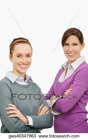 Portrait of two businesswomen standing with their arms crossed and smiling View Large Photo Image Stock Image - Portrait of two businesswomen standing with their arms crossed and smiling. Fotosearch