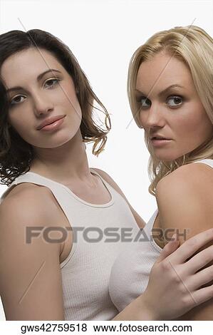 Portrait of two young women standing together View Large Photo Image Stock Photo - Portrait of two young women standing together. Fotosearch
