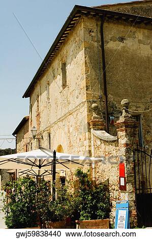 Potted plants and patio umbrellas in front of a building, Piazza Roma, Monteriggioni, Siena Province, Tuscany, Italy View Large Photo Image Stock Image - Potted plants and patio umbrellas in front of a building, Piazza Roma, Monteriggioni, Siena Province, Tuscany, Italy. Fotosearch