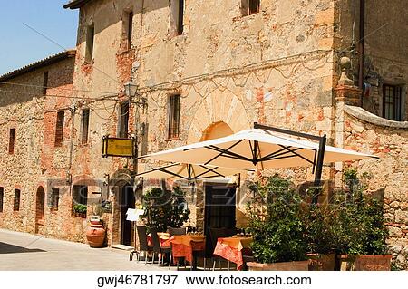 Potted plants and patio umbrellas in front of a building, Piazza Roma, Monteriggioni, Siena Province, Tuscany, Italy View Large Photo Image Stock Photo - Potted plants and patio umbrellas in front of a building, Piazza Roma, Monteriggioni, Siena Province, Tuscany, Italy. Fotosearch
