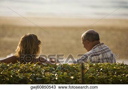 Rear view of a couple, Grande Plage, Biarritz, France View Large Photo Image Stock Image - Rear view of a couple, Grande Plage, Biarritz, France. Fotosearch