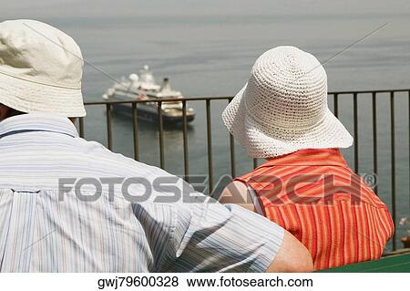Rear view of a couple looking at a cruise ship, Via Aniello Califano, Bay of Naples, Sorrento, Sorrentine Peninsula, Naples Province, Campania, Italy View Large Photo Image Stock Photo - Rear view of a couple looking at a cruise ship, Via Aniello Califano, Bay of Naples, Sorrento, Sorrentine Peninsula, Naples Province, Campania, Italy. Fotosearch