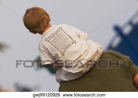 Rear view of a man carrying his son on shoulders, Nice, Provence-Alpes-Cote D'Azur, France View Large Photo Image Stock Photograph - Rear view of a man carrying his son on shoulders, Nice, Provence-Alpes-Cote D'Azur, France. Fotosearch