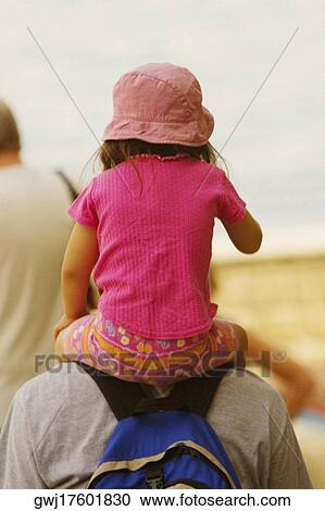 Rear view of a man carrying his daughter on shoulders, Sorrento, Sorrentine Peninsula, Naples Province, Campania, Italy View Large Photo Image Stock Image - Rear view of a man carrying his daughter on shoulders, Sorrento, Sorrentine Peninsula, Naples Province, Campania, Italy. Fotosearch