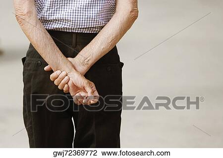 Rear view of a man standing with hands behind back, Genoa, Liguria, Italy View Large Photo Image Stock Image - Rear view of a man standing with hands behind back, Genoa, Liguria, Italy. Fotosearch