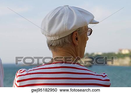 Stock Image - Rear view of a mature woman, Baie De Biarritz, Biarritz, Pyrenees-Atlantiques, France. Fotosearch