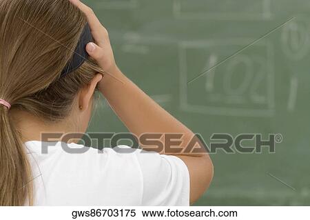 Rear view of a schoolgirl with her hands on her head View Large Photo Image Stock Photography - Rear view of a schoolgirl with her hands on her head. Fotosearch