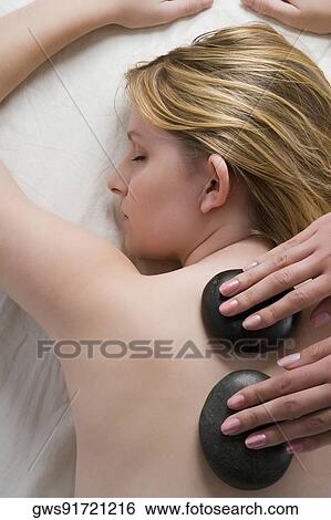 Rear view of a teenage girl getting a back massage from massage therapist View Large Photo Image Stock Photograph - Rear view of a teenage girl getting a back massage from massage therapist. Fotosearch