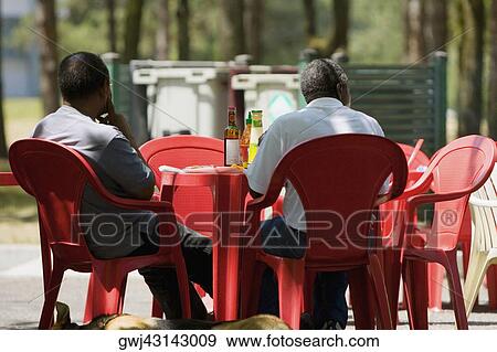 Rear view of two men sitting at a sidewalk cafe, Bordeaux, Aquitaine, France View Large Photo Image Stock Photo - Rear view of two men sitting at a sidewalk cafe, Bordeaux, Aquitaine, France. Fotosearch